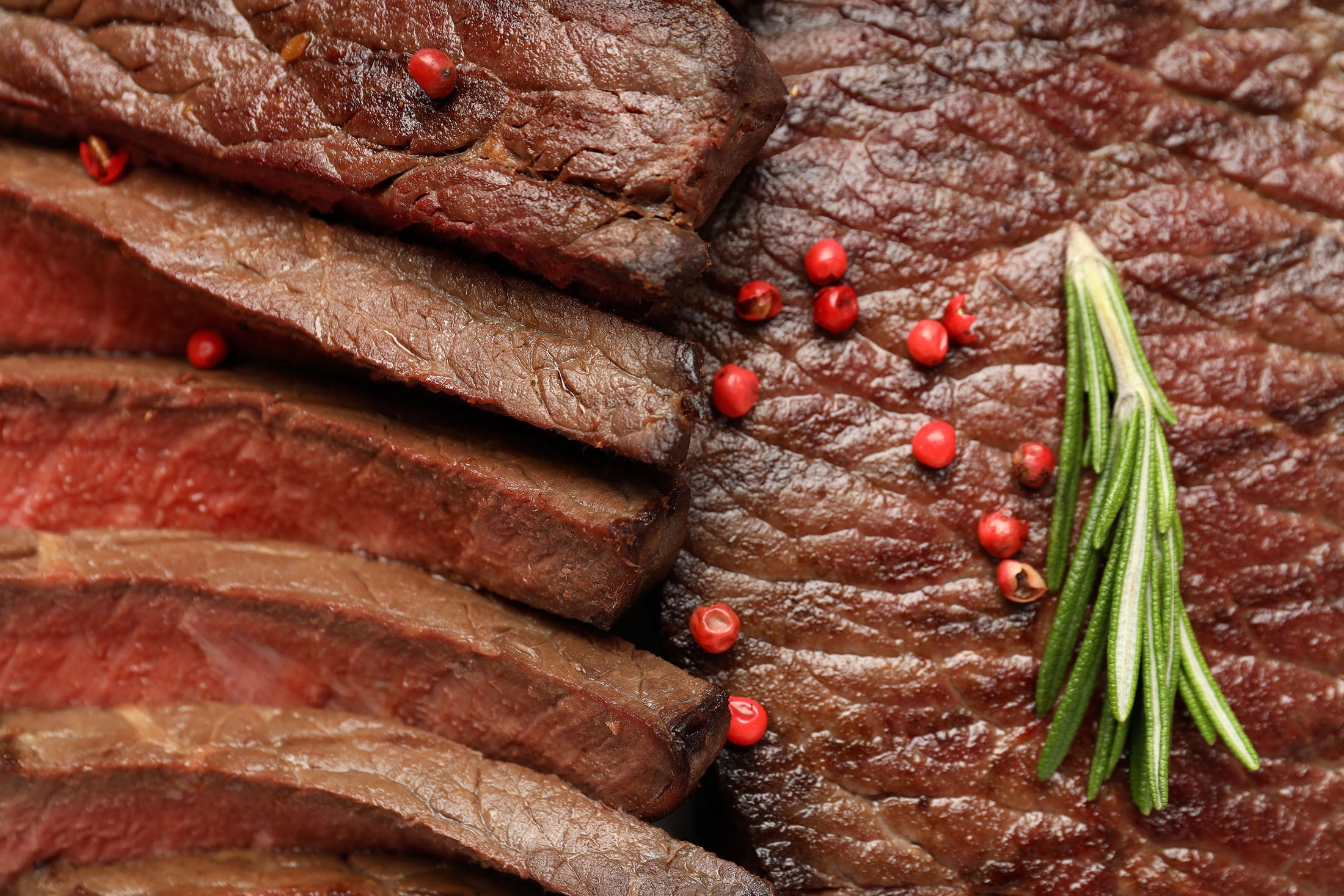 Sliced beef with red peppercorns and rosemary